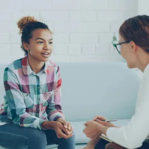 A clinician talking with a teenage girl