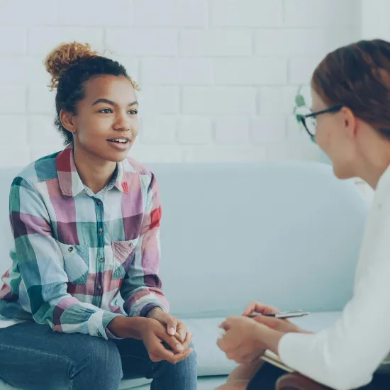 A clinician talking with a teenage girl