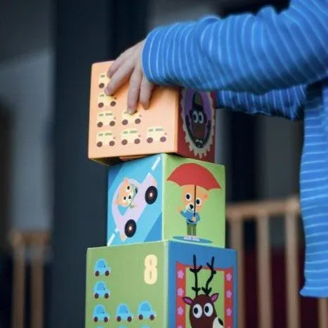 A child stacking picture blocks