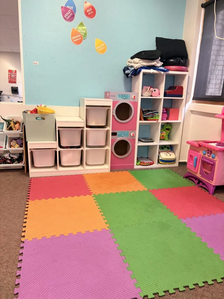 Florence clinic: play area with colorful foam mats and toy cubbies