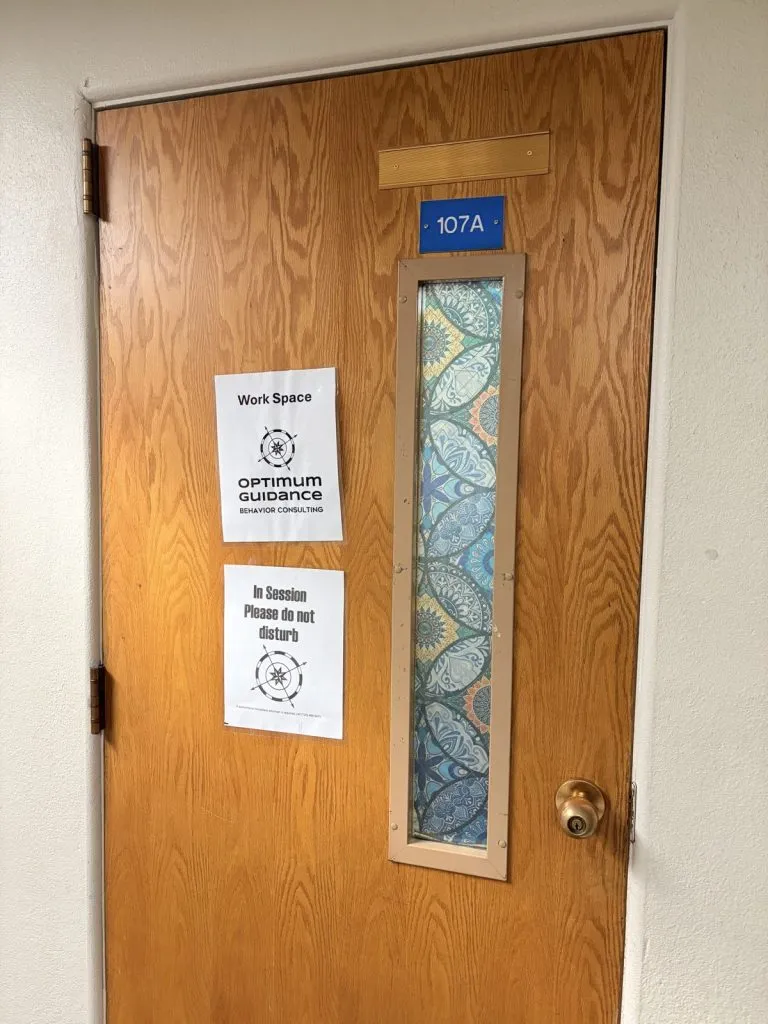 Florence clinic: therapy room door with the Optimum Guidance sign